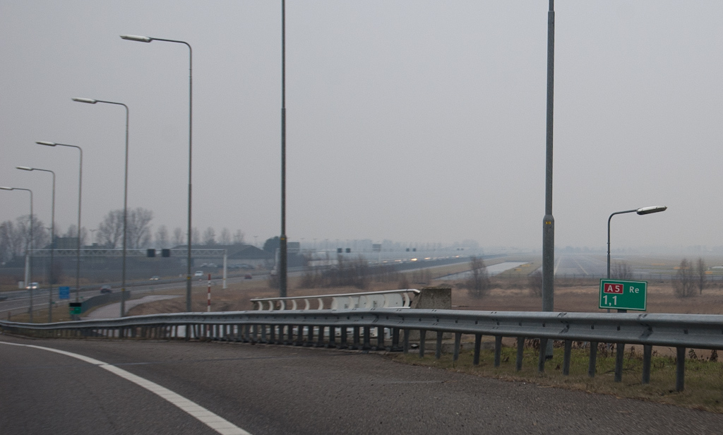 20100123-142519.jpg - Eerste A5 hectometerbordje bevindt zich tussen de viaducten over de A4 en de afrit Hoofddorp. De kilometrering loopt op in noordelijke richting. Een vreemde situatie voor een autosnelweg die uiteindelijk op de A10 aansluit. Het is een breuk met de traditie die Amsterdam ziet als het centrum van de wereld in het Nederlandse autosnelwegenland. De A1, A2, A4 en A8 hebben alle hun beginpunt in Amsterdam, met oplopende kilometrering het buitengebied in.
