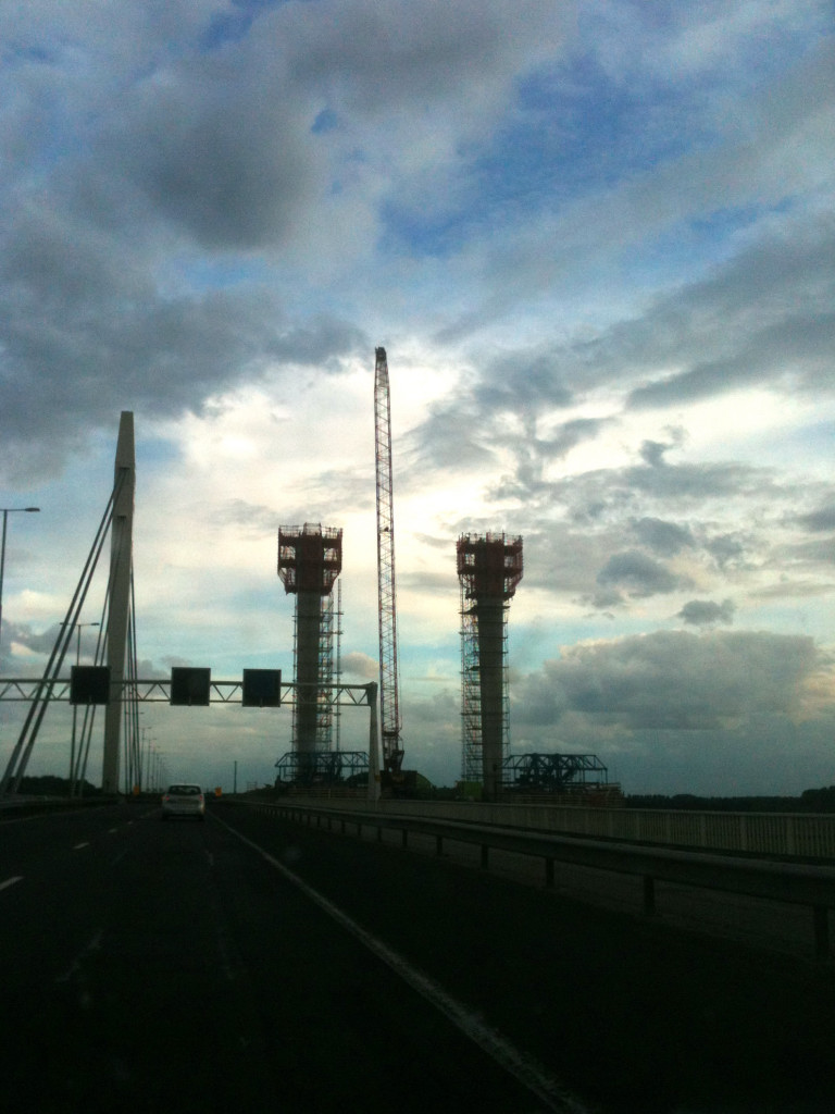 20120707-203258.JPG - Je kunt hier goed zien hoever men is gevorderd met de pylonen. Ze moeten even hoog worden als de bestaande stalen pylonen in de oude brug. Het allerhoogst reikt een bouwkraan die weer wordt verwijderd.